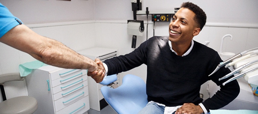 A man shaking hands with the dentist to discuss a dental bridge in Bergenfield