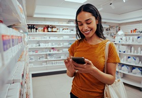 Patient in Bergenfield looking at whitening products in pharmacy
