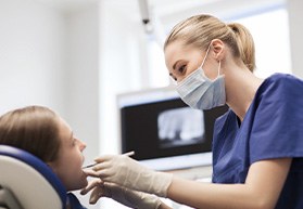 Dentist checking patient’s mouth
