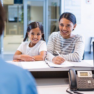 mother and daughter at front desk