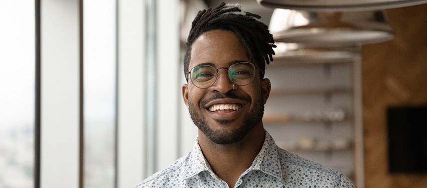 a smiling person standing in an office