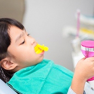 A child receiving a fluoride treatment
