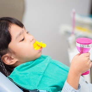 toddler getting fluoride treatment