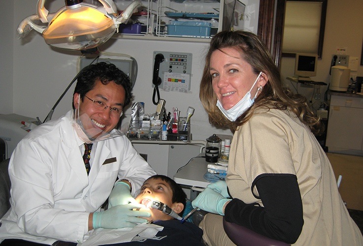 dentist working on young boy's smile