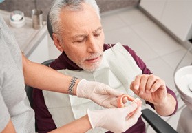 Man with dentures at the dentist