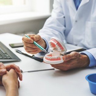 A patient consulting a dentist about denture treatment 