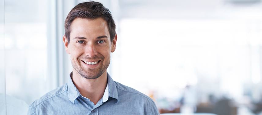 man in button down shirt smiling