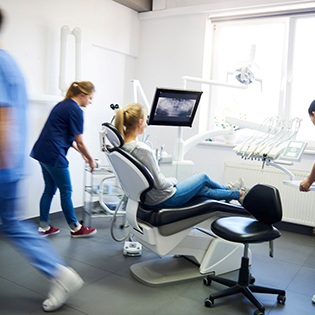 Blurred dentists helping a dental patient
