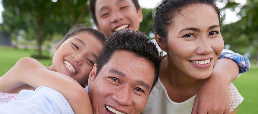 Family of four smiling