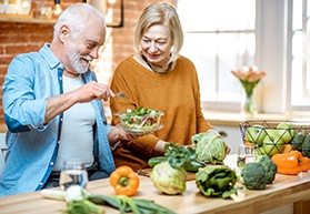 Couple eating with dental implants in Bergenfield