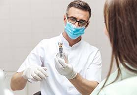 Dentist and patient discussing the cost of dental implants in Bergenfield