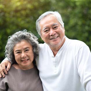 Couple with dental implants in Bergenfield
