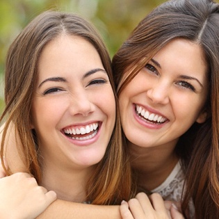 Two girls hugging and smiling