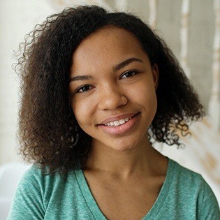 girl in green smiling