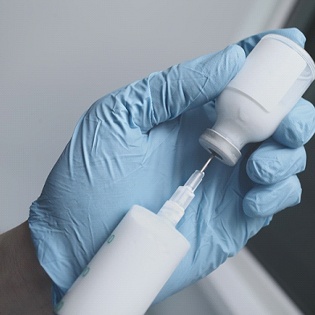 syringe pulling medication out of a tube