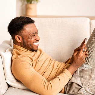 person smiling and looking at their phone