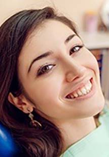 women smiling in dentist chair near Dumont