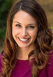 A woman with brown hair smiling near Milford