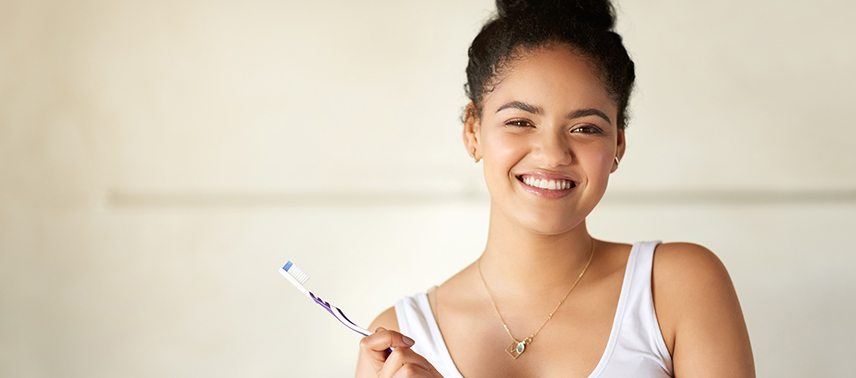 woman holding toothbrush