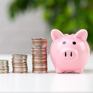 Piggy bank next to stack of coins