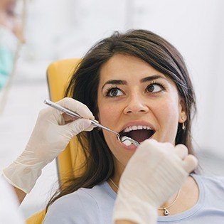 dentist pulling woman's gums back