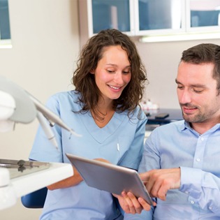 A male patient talking to his dentist
