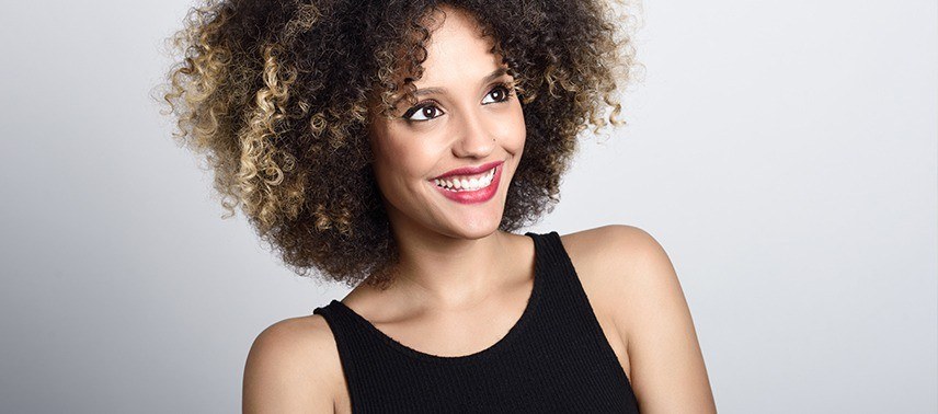 woman with curly hair smiling