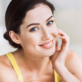 woman in yellow tank top smiling