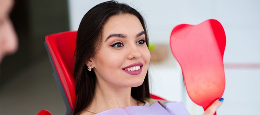 woman smiling in red mirror