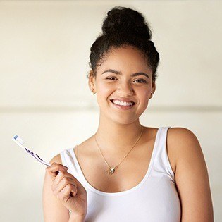 woman smiling with toothbrush