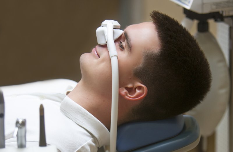 a male patient undergoing a dental procedure while receiving nitrous oxide