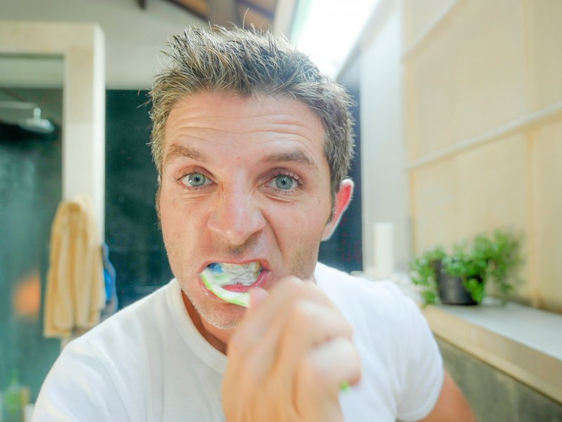 man brushing his teeth
