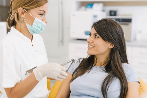 person speaking with dentist about signs of dehydration   