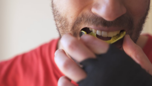 Athlete putting on his mouthguard