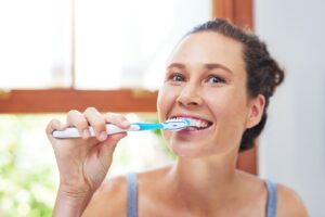 a woman brushing her teeth